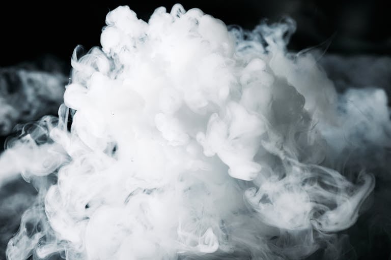 A dense, artistic smoke cloud captured with dramatic lighting, creating a mysterious effect.